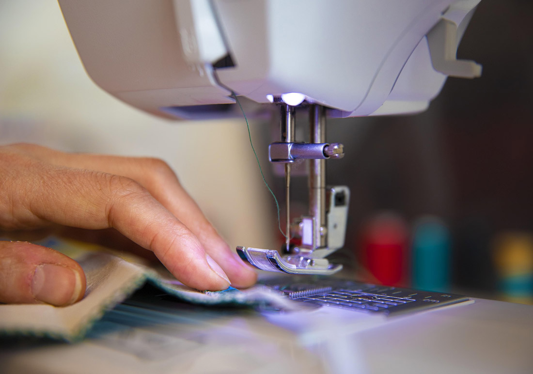 Image of a person using a sewing machine